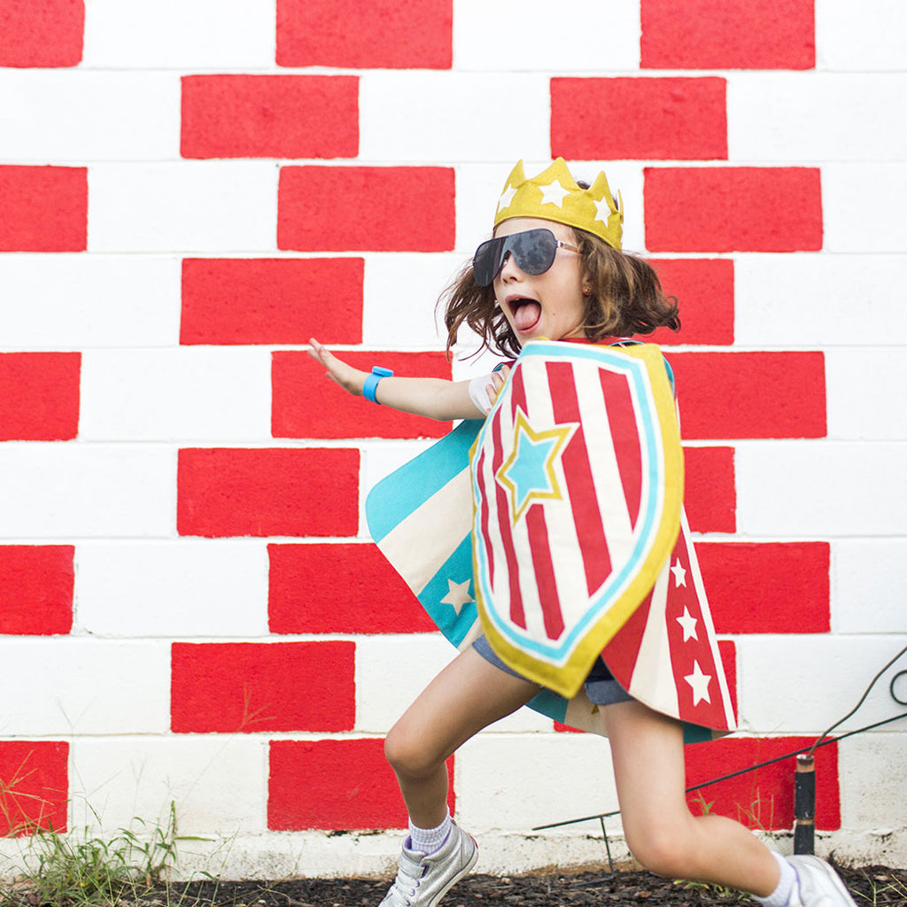 Child in action wearing superhero costume red stripes
